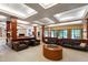 Expansive living room features a custom bar, multiple seating areas, and coffered ceilings at 6510 New Market Way, Raleigh, NC 27615