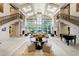 Expansive living room with soaring windows, grand staircase, and stone fireplaces exudes luxury at 6510 New Market Way, Raleigh, NC 27615