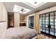 Luxurious main bedroom boasts tray ceilings, a ceiling fan, and access to a private balcony at 6510 New Market Way, Raleigh, NC 27615