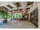 Luxurious outdoor kitchen space with high-end grill, elegant stone detailing and ceiling with arched openings at 6510 New Market Way, Raleigh, NC 27615
