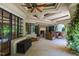Charming outdoor living space with a stone fireplace, comfortable seating and seamless indoor/outdoor living at 6510 New Market Way, Raleigh, NC 27615