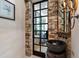 Stylish powder room with stone walls, unique vessel sink, and decorative mirror at 6510 New Market Way, Raleigh, NC 27615