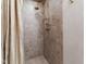 Shower featuring brown tiles and a brass shower head at 6510 New Market Way, Raleigh, NC 27615