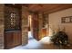 An interior view of a stone-walled wine cellar with wooden cabinetry and tile flooring creating a rustic yet refined ambiance at 6510 New Market Way, Raleigh, NC 27615