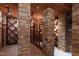 A detailed shot of a wine cellar featuring stone columns, wooden wine racks, and recessed lighting at 6510 New Market Way, Raleigh, NC 27615
