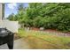 Landscaped backyard with white fence and lush greenery, perfect for relaxing outdoors at 68 Holly Berry Ln, Durham, NC 27703