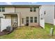 The backyard features a patio with a grill and a privacy fence for outdoor relaxation at 68 Holly Berry Ln, Durham, NC 27703