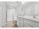 Well-lit bathroom featuring double vanity sinks, a glass-door shower, and a toilet at 68 Holly Berry Ln, Durham, NC 27703
