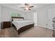 Spacious bedroom with a queen size bed, two windows for natural light and a ceiling fan at 68 Holly Berry Ln, Durham, NC 27703