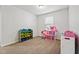 Bright bedroom featuring a toy storage unit, carpet flooring and a window at 68 Holly Berry Ln, Durham, NC 27703
