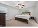 Bright bedroom with a queen size bed, two windows for natural light and a ceiling fan at 68 Holly Berry Ln, Durham, NC 27703