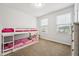 A room with carpet, a bunk bed and a window at 68 Holly Berry Ln, Durham, NC 27703