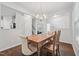 Cozy dining area with wood table set, chandelier, and easy access to other rooms at 68 Holly Berry Ln, Durham, NC 27703