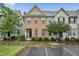 Charming townhome with brick facade, manicured landscaping, and inviting entrance at 68 Holly Berry Ln, Durham, NC 27703