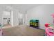 Upstairs hallway with laundry, toy storage, and neutral carpet at 68 Holly Berry Ln, Durham, NC 27703