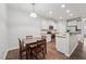 Bright kitchen with stainless appliances, adjacent dining area, and abundant natural light at 68 Holly Berry Ln, Durham, NC 27703