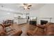 Open-concept living area with a fireplace, TV, and adjacent kitchen/dining space at 68 Holly Berry Ln, Durham, NC 27703