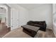 Cozy living room showcasing a comfortable couch, coffee table, and neutral carpet at 68 Holly Berry Ln, Durham, NC 27703