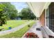 Expansive backyard features a lush lawn, vibrant flowers, and an outbuilding at 816 Miller Rd, Hillsborough, NC 27278