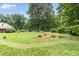 Large backyard with mature trees, manicured landscaping, and plenty of open space at 816 Miller Rd, Hillsborough, NC 27278