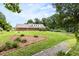 Expansive backyard featuring lush lawn, mature trees, and a charming brick home at 816 Miller Rd, Hillsborough, NC 27278