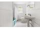 Bright bathroom featuring beadboard paneling, white fixtures, and a window view at 816 Miller Rd, Hillsborough, NC 27278