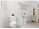 Well-lit bathroom features beadboard paneling, pedestal sink, and classic white fixtures at 816 Miller Rd, Hillsborough, NC 27278