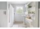 Bright bathroom featuring a pedestal sink, vanity, and window offering natural light at 816 Miller Rd, Hillsborough, NC 27278