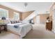 Spacious carpeted bedroom with dormer windows, featuring a cozy lounge area at 816 Miller Rd, Hillsborough, NC 27278