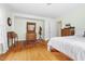 Cozy bedroom with hardwood floors featuring antique vanity and neutral color palette at 816 Miller Rd, Hillsborough, NC 27278