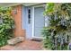 Elegant blue front door with brick accents and decorative foliage at 816 Miller Rd, Hillsborough, NC 27278