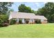 Charming brick ranch home featuring a well-manicured lawn and landscaping at 816 Miller Rd, Hillsborough, NC 27278