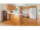 Bright kitchen with oak cabinets, modern appliances, and a breakfast bar for casual dining at 816 Miller Rd, Hillsborough, NC 27278