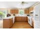 Charming kitchen with oak cabinets, white countertops, and appliances provides a warm, inviting atmosphere at 816 Miller Rd, Hillsborough, NC 27278