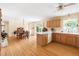 Open kitchen features wooden cabinets, dining table, and sliding glass door to the yard at 816 Miller Rd, Hillsborough, NC 27278