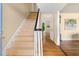 A bright stairway with hardwood steps and a black and white banister at 816 Miller Rd, Hillsborough, NC 27278
