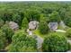 Aerial view showcasing a home surrounded by dense trees and landscaping in a suburban neighborhood at 8405 Hempton Cross Dr, Wake Forest, NC 27587