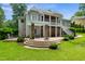 Spacious backyard featuring a patio, pergola, stone pillars, and well manicured lawn at 8405 Hempton Cross Dr, Wake Forest, NC 27587