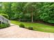 Well-maintained backyard with a grassy area, landscaping, and a staircase leading to the upper level at 8405 Hempton Cross Dr, Wake Forest, NC 27587