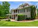 Beautiful backyard featuring a patio, pergola, green grass, and a three story home at 8405 Hempton Cross Dr, Wake Forest, NC 27587