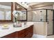Bathroom features dual sinks, a large framed mirror, and a glass-enclosed shower at 8405 Hempton Cross Dr, Wake Forest, NC 27587