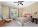 Bright bedroom featuring a ceiling fan, a window and a comfy glider with ottoman at 8405 Hempton Cross Dr, Wake Forest, NC 27587