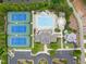Aerial showcasing pool, tennis courts, clubhouse, playground, parking and landscaping at 8405 Hempton Cross Dr, Wake Forest, NC 27587
