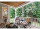 Inviting covered porch with comfortable seating and wooded views at 8405 Hempton Cross Dr, Wake Forest, NC 27587