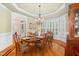 Traditional dining room with hardwood floors, wainscoting and an elegant chandelier at 8405 Hempton Cross Dr, Wake Forest, NC 27587