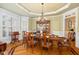 Dining room with a large table and chairs, plus a decorative cabinet for storage at 8405 Hempton Cross Dr, Wake Forest, NC 27587
