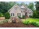 Two-story brick and stone home with professional landscaping, dark shutters and front-facing gables at 8405 Hempton Cross Dr, Wake Forest, NC 27587