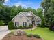 Elegant brick home with stone accents, manicured lawn, and lush landscaping at 8405 Hempton Cross Dr, Wake Forest, NC 27587