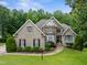 Beautiful two-story home with brick and stone facade, lush landscaping, and a well-maintained lawn at 8405 Hempton Cross Dr, Wake Forest, NC 27587