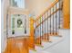 Grand foyer with hardwood floors, a staircase, and a view of the front entrance at 8405 Hempton Cross Dr, Wake Forest, NC 27587